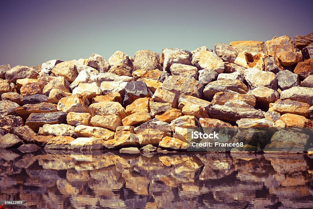 Rock wall protection from the waves Rock wall protection from the waves - concept image At The Edge Of Stock Photo