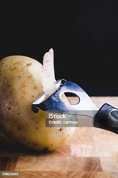 Peeling Potatoe Stock Photo - Download Image Now - Black Background, Brown, Close-up