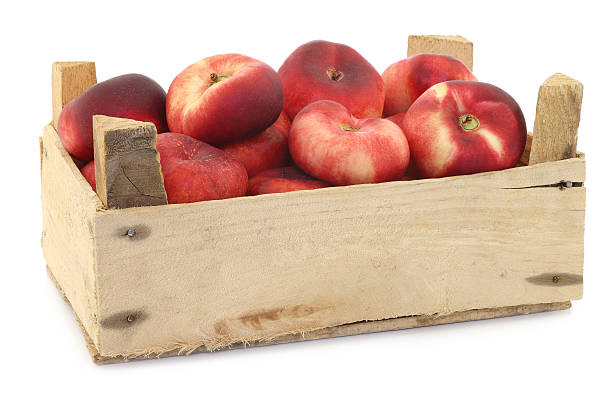 istock flat nectarines in a wooden crate 518622719