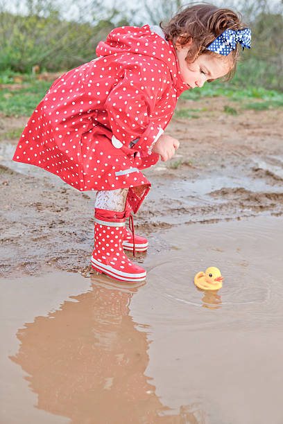 istock Playing with her water toys on muddly puddles 518622742