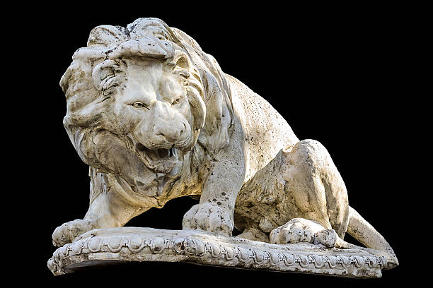 istock Ancient statue of a reclining lion isolated on black 518624190