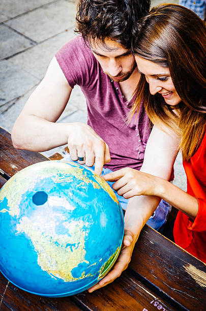 istock Young Couple Thinking About Where To Go On Trip 518624681