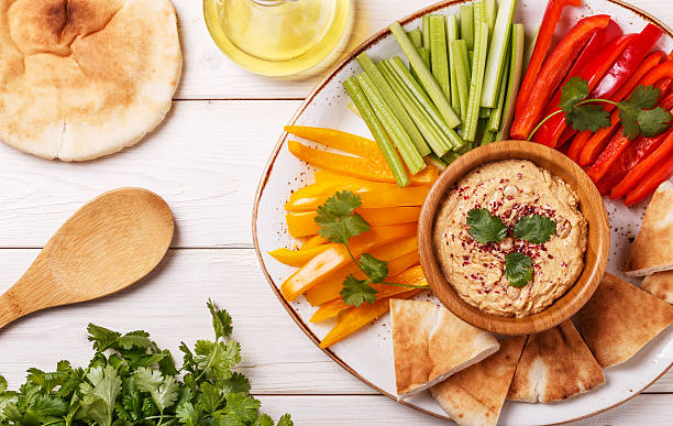 istock Homemade hummus with assorted fresh vegetables and pita bread. 518624738