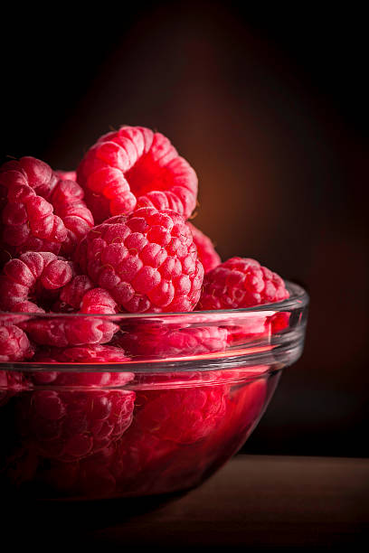 istock Raspberries in glass jar 518625300