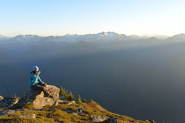 istock Woman hiker relaxing with drink in mountains 518625760