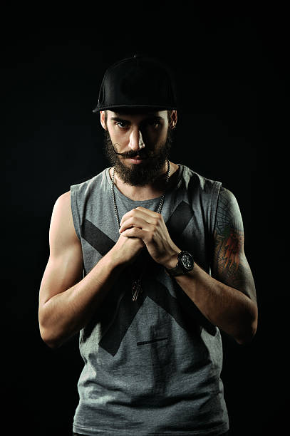 The aggressive man with tattoos flexing his fists
