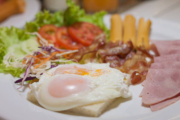 istock fried egg, bacon and sausage for healthy breakfast. 518626018
