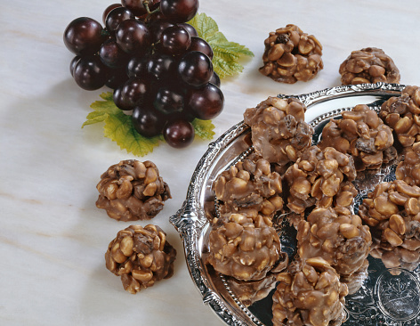 a tray of peanut and raisin clusters
