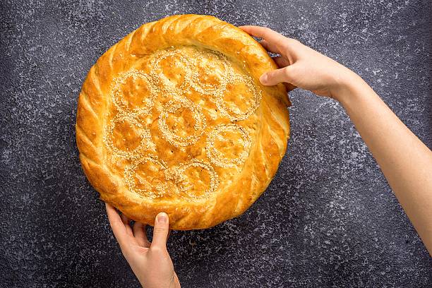 istock Woman hands holding tasty fresh bread, top view 518627568