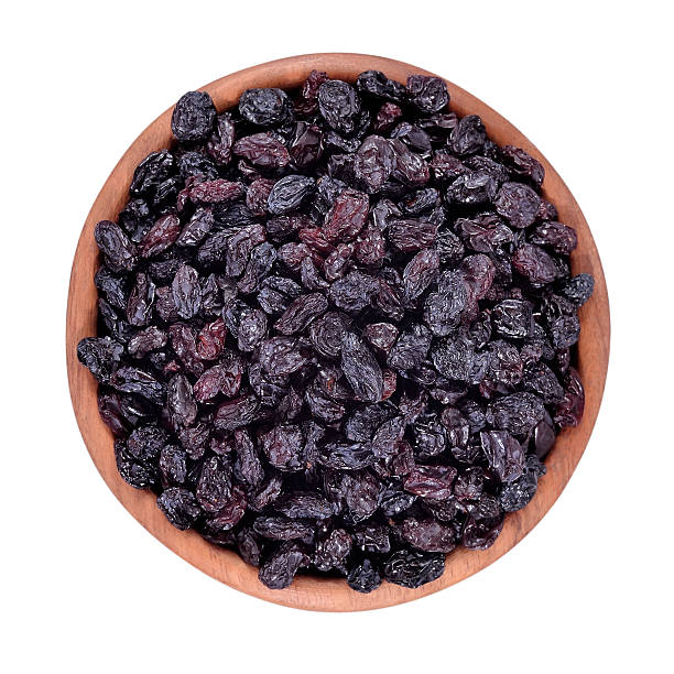 istock Dark raisins in a wooden bowl 518627797