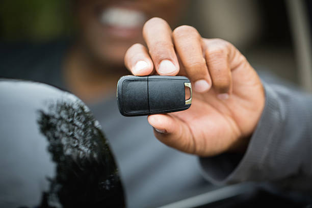 Man holding a key to a new car