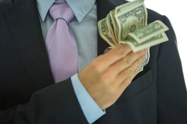 istock Businessman holding US paper currency. Studio shot. 518640303