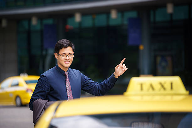 istock asian businessman calling taxi car leaving work 518640469