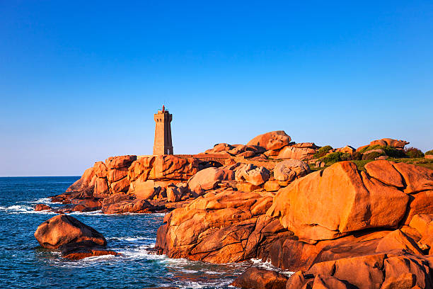 istock Ploumanach lighthouse sunset in pink granite coast, Brittany, Fr 518642029