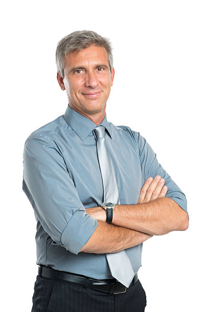 Confident Mature Businessman Portrait Of Smiling Confident Mature Businessman With Arms Crossed Looking At Camera Isolated On White Background mid adult men stock pictures, royalty-free photos & images