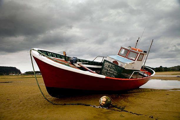 istock Fishing boat at low tide 518642493