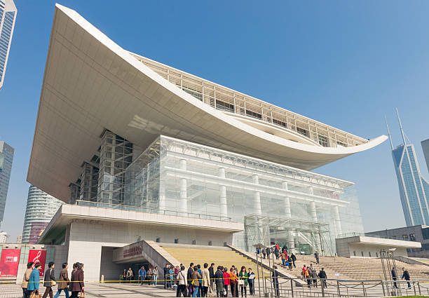 Shanghai, China - March 6, 2013: People visiting the Shanghai Grand Theatre. Opened in 1998, the theatre is one of the largest in the world, and a major Shanghai landmark.