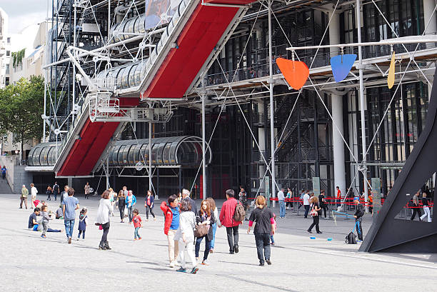 Centre Pompidou Paris, France - August 29, 2014: Modern art museum centre Pompidou. Before the museum are people on place du Georges Pompidou. pompidou center stock pictures, royalty-free photos & images
