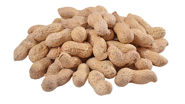 istock Heap of whole peanuts on a white 518643275