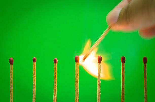 istock burnning match setting on green background for ideas and inspiration 518645295