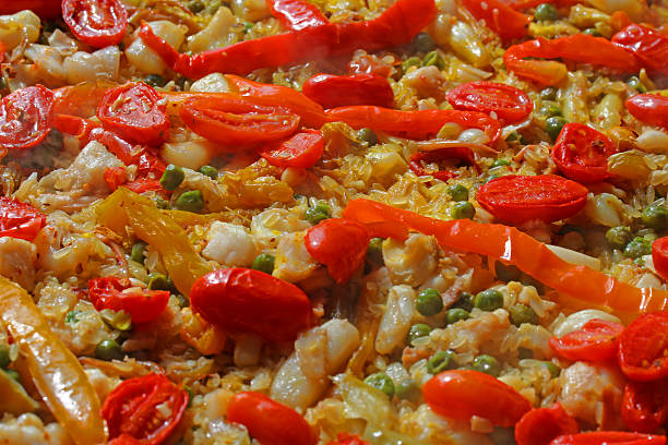 istock Rice paella with seafood, red tomatoes and peppers 518645673