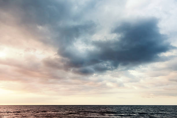 istock Colorful dramatic sky with clouds over sea water 518648294