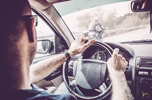 Man driving - motorbike overtaking a car