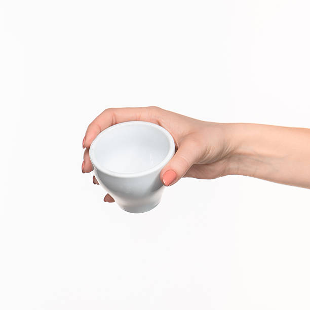 istock Woman hand with cup on white background 518650176