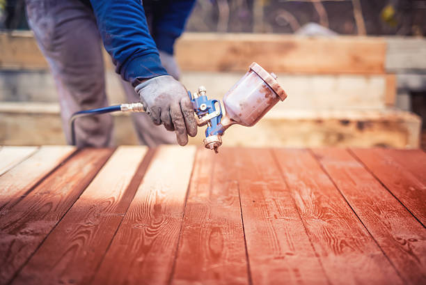 istock Industrial handyman, construction worker painting with spray 518650270