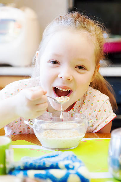 istock Girl having Breakfast in the kitchen 518651726