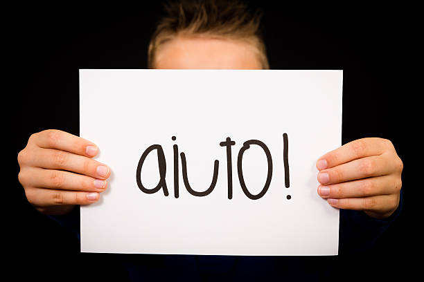 istock Child holding sign with Italian word Aiuto - Help 518652720