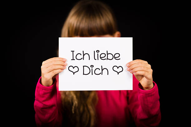 istock Child holding sign with German words Ich liebe Dich 518653336