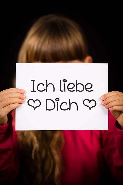 istock Child holding sign with German words Ich liebe Dich 518653350