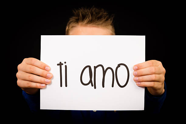 Child holding sign with Italian words Ti Amo