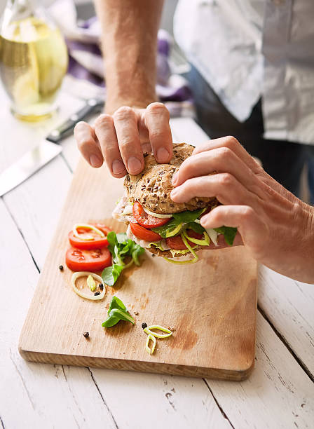 istock Man take a big sandwich in hands 518655534
