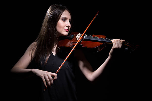istock Smiling woman playing on fiddle 518655630