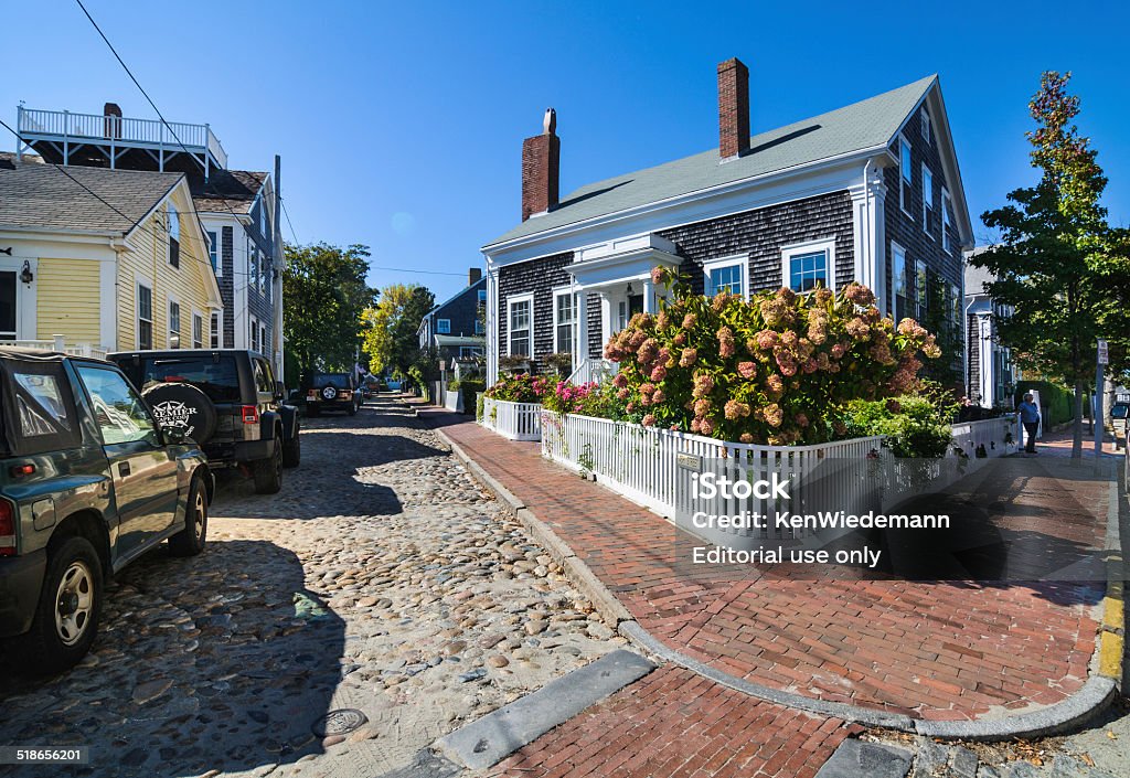 Hydreangas on Ash Street Nantucket, Massachusetts, USA- September 28, 2014: Hydreangas and roses grow along the fence line on the corner of Ash Street and North Water Street in Nantucket Village  on a late September afternoon Nantucket Stock Photo