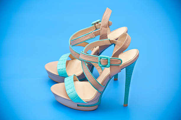 istock women's shoes on a turquoise blue background 518656759