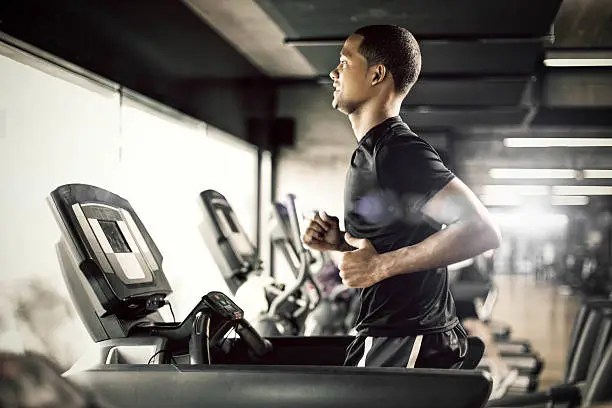 Photo of Healthy man Running on Treadmill