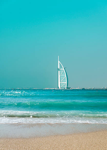 Dubai, United Arab Emirates - March 25, 2016: View of Burj Al Arab hotel from the Jumeirah beach. Burj Al Arab is one of the Dubai landmarks, and one of the world's most luxurious hotels with 7 stars.