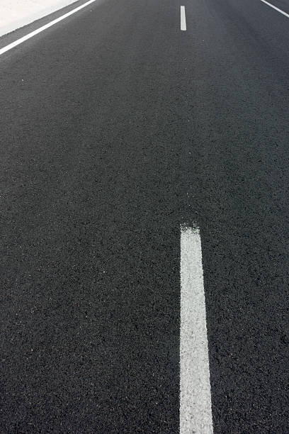 istock background texture of rough asphalt road 518657355
