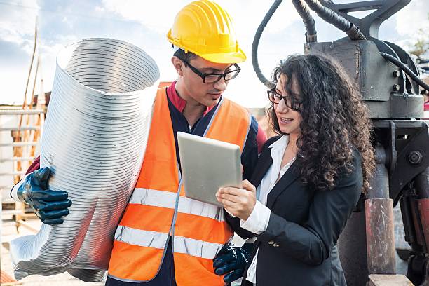 istock Manager and Manual Worker in Metal Landfill 518657425