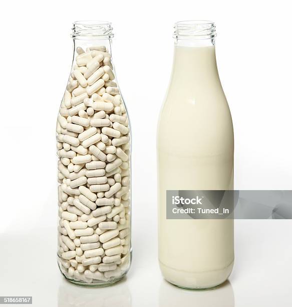 Two Milk Bottles One Filled With Milk Stock Photo - Download Image Now - Lactose Fermentation, Allergy, Allergy Medicine