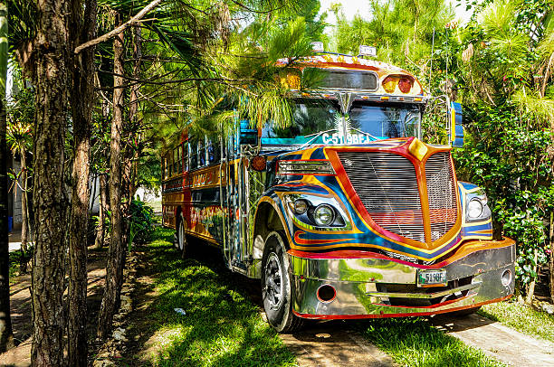 Poptún, Guatemala - November 7, 2014: Chicken Bus at the jungle. These multi colored buses are the transportation used by local people. Colors are very bright and intense. This kind of style is very typical in Guatemala.