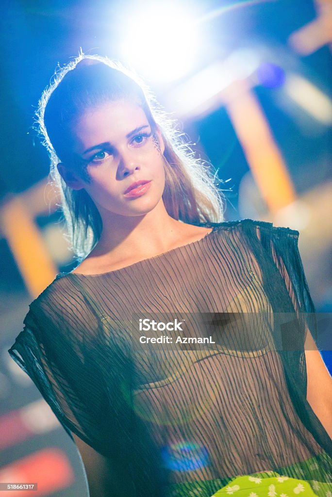 Fashion model Beautiful young womwn walking on a catwalk. Catwalk - Stage Stock Photo