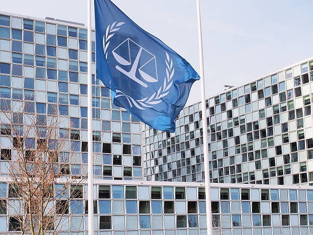 The flag and the new International Criminal Court The Hague, Netherlands - March 27, 2016: The flag and the International Criminal Court at the new 2015 opened ICC building. the hague photos stock pictures, royalty-free photos & images