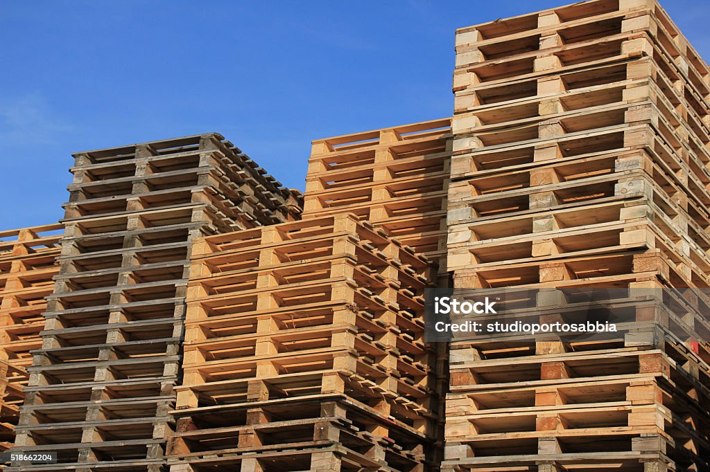 Pallet storage Stacked wooden pallets at a storage Pallet - Industrial Equipment Stock Photo