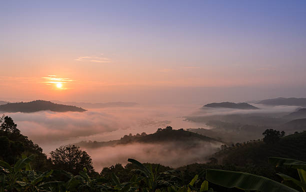 Sunrise with sea of fog above Mekong river Beautiful sunrise landscape with sea of fog above Mekong river at Phu Huai Isan mountain viewpoint in Nong Khai Province, Thailand nong khai stock pictures, royalty-free photos & images