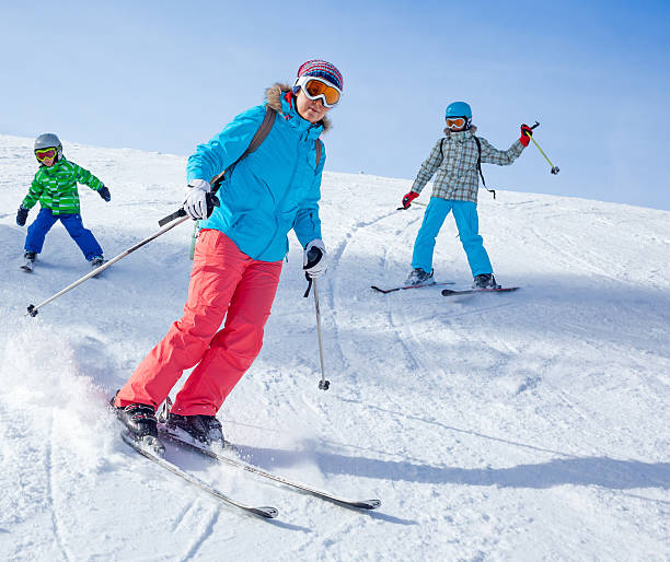 istock Two kids with mother enjoying winter vacations. 518674875