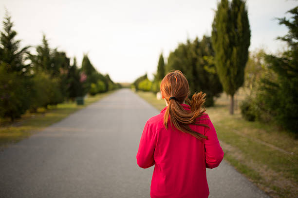 istock Young woman running footpath 518675412